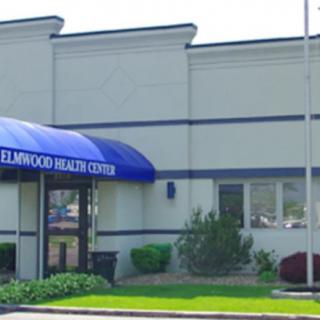 A health center building with a blue awning.
