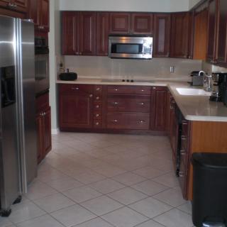 A modern kitchen with wooden cabinets and stainless steel appliances.