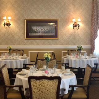 A beautifully arranged dining room featuring elegant tables and chairs, enhanced by tasteful decor.