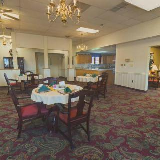 A cozy dining area with elegantly set tables and traditional decor.