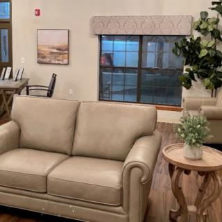 A cozy living room with a beige sofa and modern decor.
