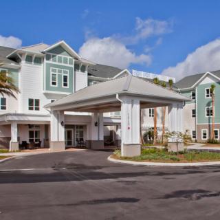 A modern residential building with a welcoming entrance and well-maintained landscaping.