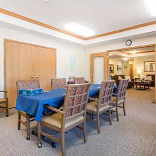 A well-lit dining or meeting area featuring a long table and chairs arranged neatly.