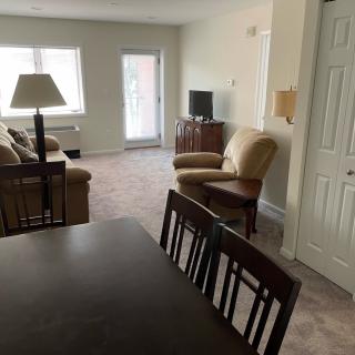 A cozy living room with seating and a TV setup.