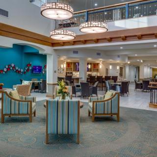 A modern hotel lobby with comfortable seating and elegant lighting.