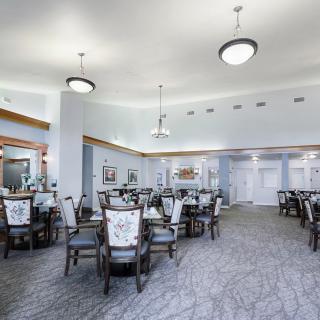 Spacious dining area with elegant furniture and chandeliers.