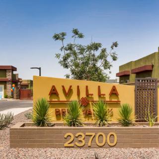 Entrance sign of the Avilla apartment complex, featuring modern design and landscaping.