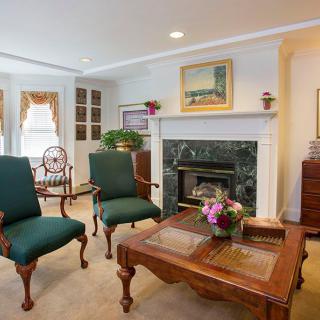 A cozy living room featuring classic furniture and a fireplace.