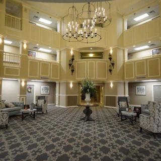 A luxurious hotel lobby featuring elegant chandeliers, comfortable seating, and sophisticated decor.
