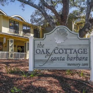 The Oak Cottage of Santa Barbara, a welcoming two-story building surrounded by trees.