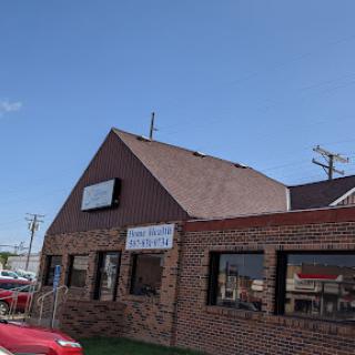 A brick restaurant building under a clear blue sky.