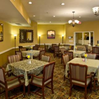 A well-lit dining room with neatly arranged tables and chairs, creating an inviting atmosphere.