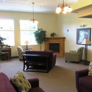A cozy living room with comfortable seating, a fireplace, and ample natural light.