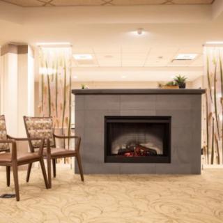 A cozy lobby area featuring a modern fireplace and comfortable seating.