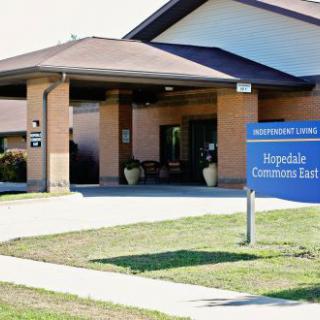 The entrance of a healthcare facility with signage indicating it is a hospice.
