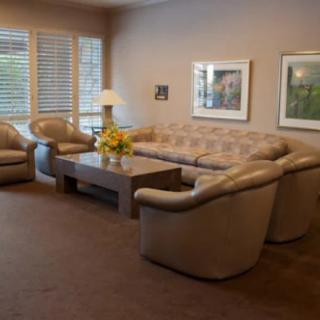 A cozy living room with comfortable seating and decorative elements.