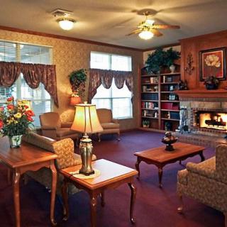 Cozy living room with a lit fireplace and comfortable seating.