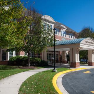 A building entrance with a covered walkway on a sunny day.