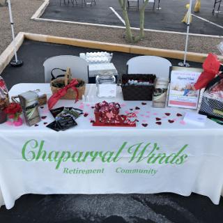 A promotional booth for Chapparal Winds, showcasing community engagement materials and offerings.
