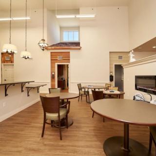 A modern dining room with elegant furniture and warm lighting.