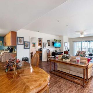 A cozy open floor plan living space with a view of the kitchen, dining area, and comfortable seating.