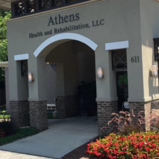 Entrance to Athens Health and Rehabilitation, LLC, with landscaped plants in front.