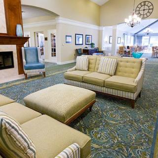 A spacious and modern living room with comfortable seating and a fireplace.