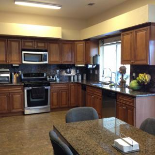 Spacious kitchen with wooden cabinets and stainless steel appliances.