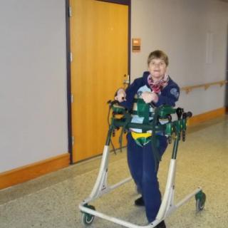 A person using a mobility aid indoors for rehabilitation.