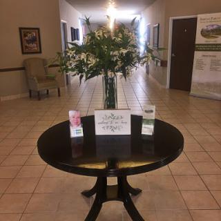 A welcoming lobby featuring a beautiful floral arrangement on a round table.