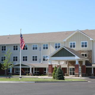 A residential building with an American flag displayed outside.