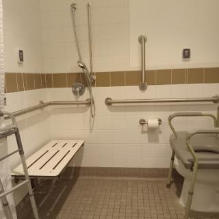 An accessible bathroom equipped with safety features for individuals with disabilities.