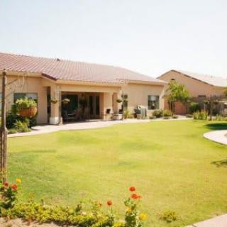 A spacious backyard with a well-maintained lawn and garden area.