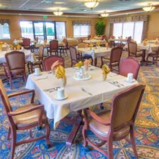 Elegant dining area with neatly arranged tables and chairs, featuring a warm and inviting atmosphere.