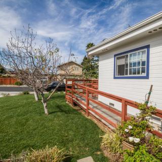A suburban house with a well-maintained lawn and garden.
