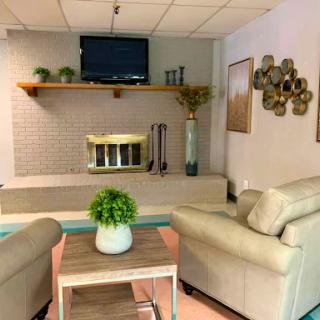 A cozy living room setup featuring comfortable seating and decorative accents.