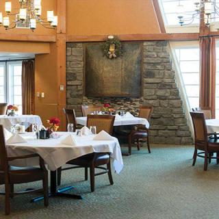 A well-decorated restaurant dining area with neatly arranged tables and chairs.