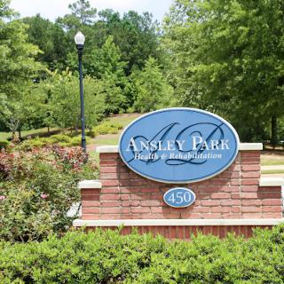 Welcome sign for a residential community surrounded by lush greenery.
