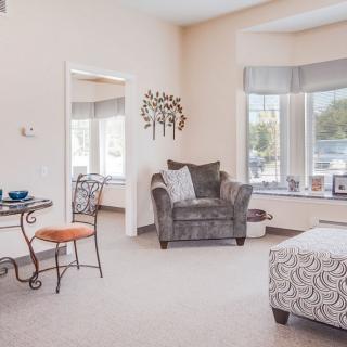 A bright and cozy living room with comfortable furniture and large windows letting in natural light.