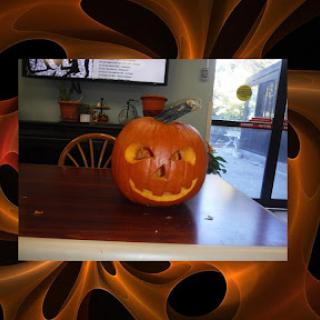 A creatively carved Halloween pumpkin displayed on a table.