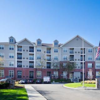 A modern residential apartment building under a clear blue sky.