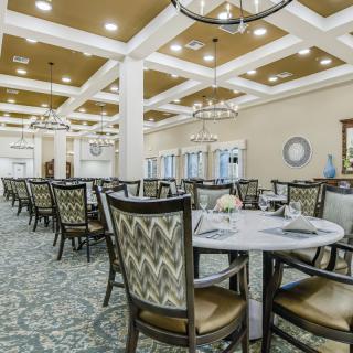 An elegant dining room with beautifully arranged tables and chairs.