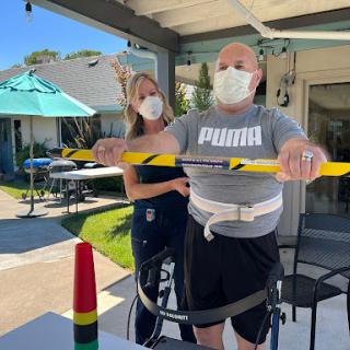 A physical therapy session outdoors, focusing on strength and rehabilitation activities.
