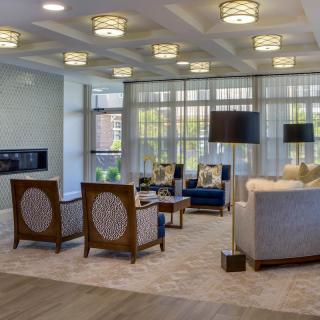 A modern and elegantly designed living room with stylish seating and unique lighting fixtures.