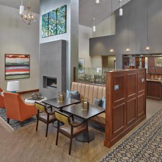 A modern dining area with booth seating and warm wooden accents.