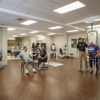 A group of people engaged in physical therapy at a rehabilitation center.