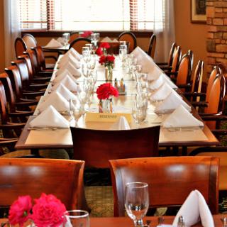 A beautifully arranged dining table ready for an elegant meal with decorative flowers.
