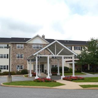Exterior view of a residential building with a landscaped entrance.