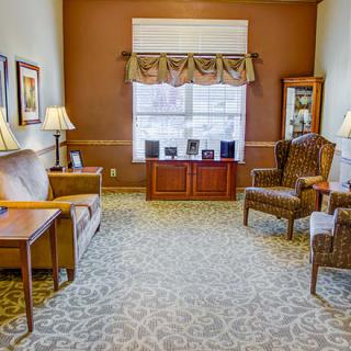 A cozy living room with elegant furnishings and warm lighting.