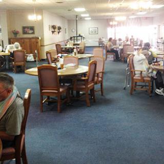A spacious dining area filled with people enjoying their time together.